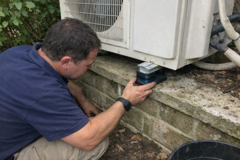 an illustrative image of an engineer adjusting vibration pads on an AC unit