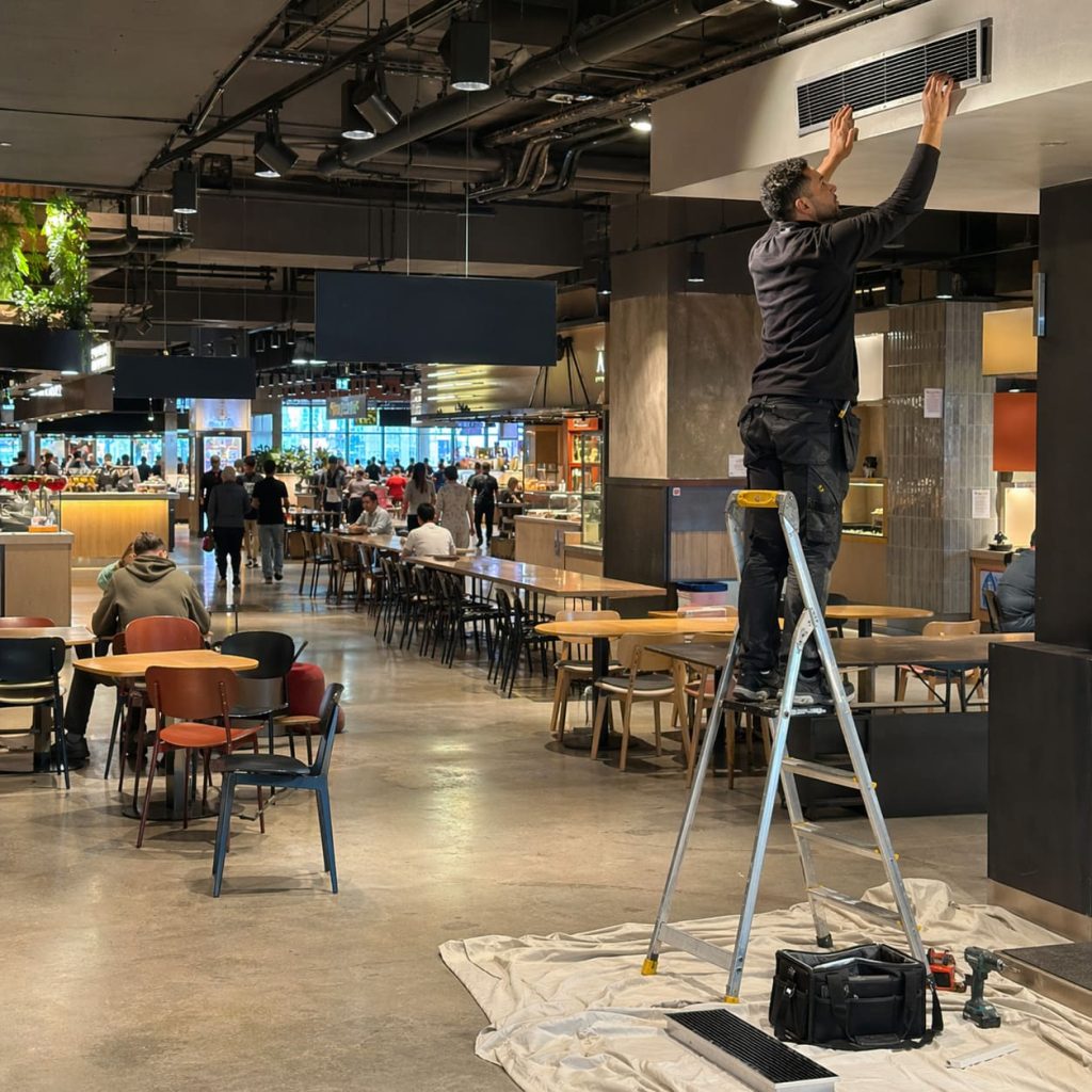 Retail Restaurant Cooling Bulkhead Grille Installation in Food Hall - Illustrative Image